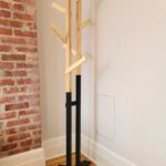 ree standing coat rack with modern industrial look: black base with wooden top consisting of angled arms